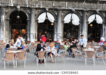 VENICE - APRIL 30:People eats in a restaurant on April 30 2011 in St Mark\'s Square, Venice Italy.Each year the town receives 18 million tourists. This equates to approximately 50,000 visitors each day