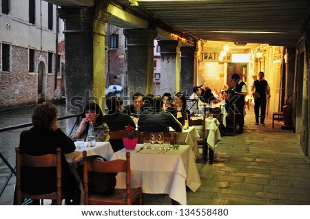 VENICE - APRIL 30:People eats in a restaurant on April 30 2011 in St Mark\'s Square, Venice Italy.Each year the town receives 18 million tourists. This equates to approximately 50,000 visitors each day