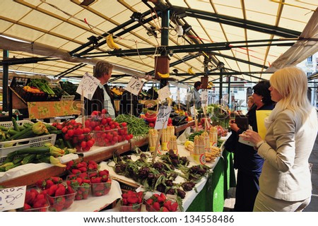 VENICE - MAY 02:Shopping in the Rialto Market on May 02 2011 in Venice, Italy.In Italy it\'s forbidden to touch products on display and the vendor is choose and give their best products to the customer