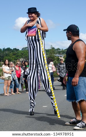 MANGONUI, NZ - APRIL 06: Woman walk on stilts on April 06 2013 in Mangonui water front festival, New Zealand.Stilt walking is originated in China thousands of years ago.