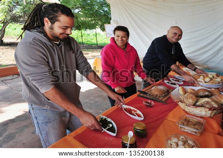 ASHDOD - JAN 22:Israeli people serve bread and salads on Jan 22 2010 in Ashdod, Israel.Israels culinary traditions comprise foods and cooking methods that span three thousand years of history.