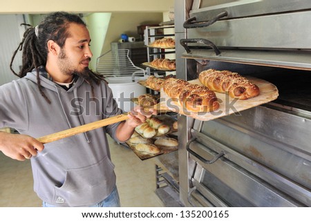 ASHDOD - JAN 22:Man bake Challah bread on Jan 22 2010 in Ashdod,Israel.It commemorates the manna that fell from heavens when the Israelites wandered the desert for 40 years after the Exodus from Egypt