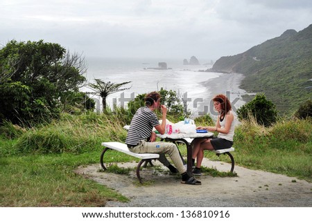WEST COAST, NZ - APRIL 19:Tourists eat lunch on a west coast overlook point on April 19 2009.The West Coast has been numbered among the \