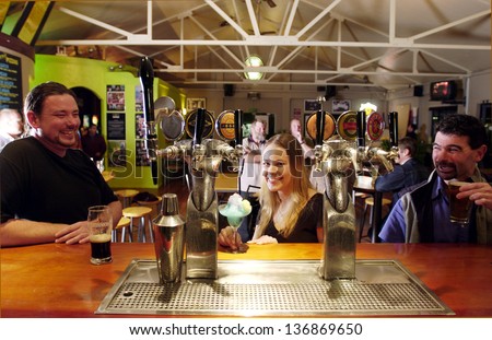 KERIKERI, NZ - AUG 15:People drink alcohol in a pub on Aug 15 2004.The minimum legal purchase age in NZ is 18.If young people wish to purchase alcohol they need to provide photographic proof of age.