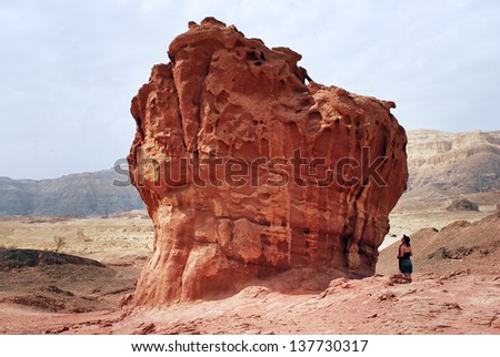 TIMNA, ISRAEL - OCT 15 2008:Visitors looks at mushroom rock formation in Timna Park. It\'s the worlds first copper production center founded my the Egyptian in the in Timna valley over 5000 years ago.