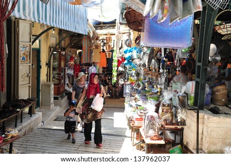 NAZARETH, ISRAEL - JUNE 15:Visitors in Nazareth market on June 15 2009.The city is a center of Christian pilgrimage, with many shrines commemorating New Testament events.