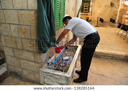 HEBRON, ISR - SEP 08 2009:Jewish man Handwashing at the Cave of the Patriarchs in Hebron. According to tradition all the Patriarchs and Matriarchs of the Jewish people believed to be buried there.