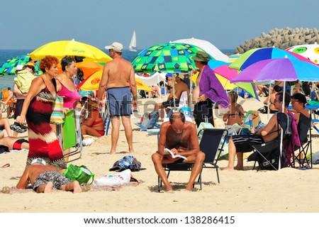ASHKELON - OCT 16:Israelis in Ashkelon beach on Oct 16 2010.It's the southernmost city on the Israeli Mediterranean shoreline with 12 km of beautiful beaches attracts Israelis and foreign tourists.