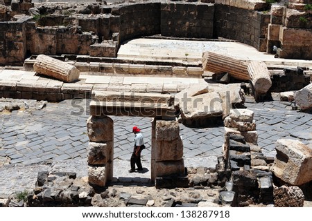 BEIT SHEAN,ISR - JUNE 17:Visitor walks near Pillars in Ancient Beit Shean on June 17 2009.Beit She\'an is one of the most ancient sites in Israel: it was first settled 5-6 thousand years ago.