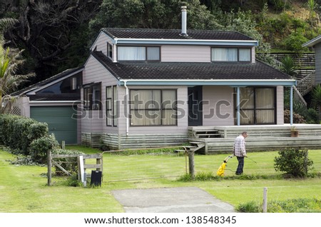 TAUPO BAY, NZ - MAY 11:Man carries a weedkiller sprayer spraying his home garden a on May 11 2011.New Zealand is among the countries experiencing a rapid rise in bed bug infestations.