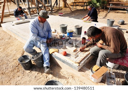 JERICHO - DEC 14:Mosaic artisans during work on Dec 14 2008.The earliest known examples of mosaics made of different materials were found in Mesopotamia dated to the second half of 3rd millennium BC.