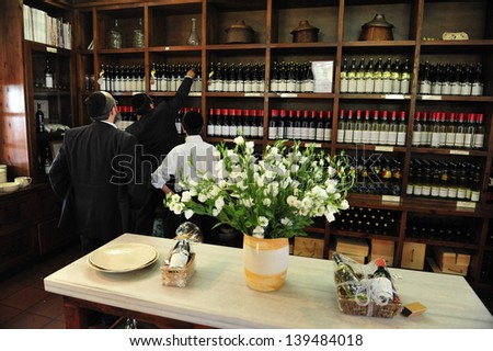 ZIKHRON,ISR - AUG 07:People buy wine from local winery on Aug 07 2009.Wine has been produced in the Land of Israel since biblical times. In 2011, Israeli wine exports totaled over $26.7 million.