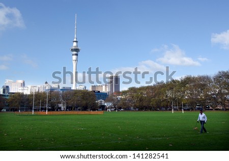 AUCKLAND - MAY 27:Man walks his dog in Victoria Park on May 27 2013.It\'s a famous park and sports ground in Auckland City, New Zealand.