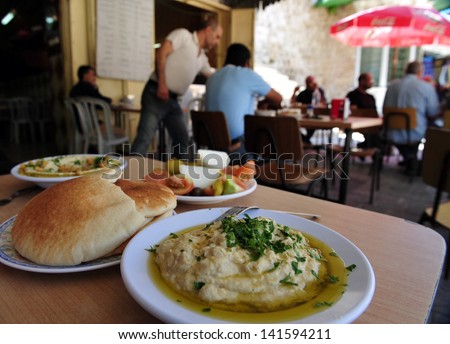 Acre, Isr - May 13:People Eats Hummus In Acre On May 13 2009.Hummus Is One Of The Most Popular Food Products To Emerge From The Mediterranean Region And A Common Part Of Everyday Meals In Israel.