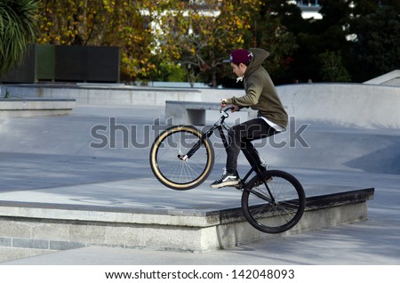 AUCKLAND, NZ - MAY 27:Young man jump with his BMX Bike Victoria park on May 27 2013.It became official Olympic sport in the 2008 Summer Olympic Games in Beijing, China.