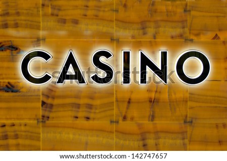 Casino sign on a marble wall. Concept photo of gambling, addict\
,chance, lost, risk, addiction, money, spending and wealthy lifestyle.