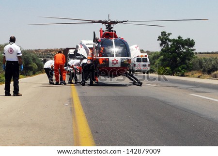 ASHKELON, ISR - JUNE 10:Israeli rescue helicopter evacuate injures after a deadly car accident on June 10 2008.The first air ambulance service originated in Australia during 1928.