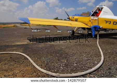 BEERI, ISR - MAR 26:An Israeli fertilizing plane being fueled on a runway on March 26 2008.Crop dusting with insecticides began in the 1920s in the United States.