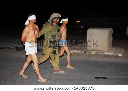 NACHAL OZ, ISR - AUG 02:Fatah men are fleeing into Israel with the help of Israel's Defense Force and emergency services after bloody clashes in the Gaza Strip on August 2, 2008 in Nachal Oz, Israel.