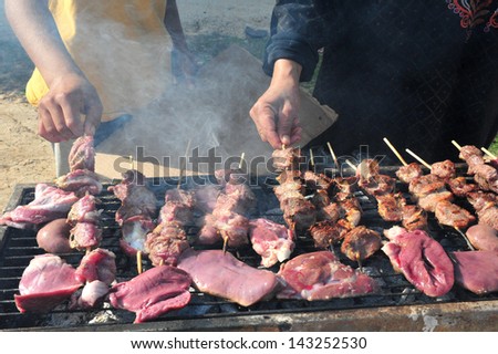LAKIYA,ISR - DEC 12:Muslim cooks lamb meat on Eid al-Adha, Dec 8 2008.The festival is celebrated by sacrificing a lamb or other animal and distributing the meat to relatives, friends, and the poor.