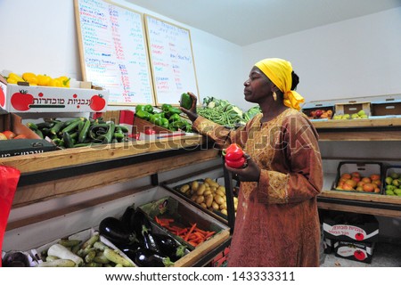 DIMONA,ISR - NOV 06:Black Hebrews woman buy vegetables on Nov 3 2008.The group maintains a vegan diet as part in their belief in God\'s promises to Adam in Genesis.