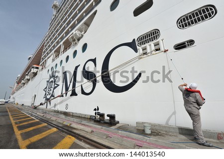 ASHDOD, ISR - MAR 09:Worker cleans the MSC - SPLENDIDA on March 09 2010.It\'s on of the most luxurious ship sail in the Mediterranean sea. It can accommodate 4000 passengers and 2000 crew members.