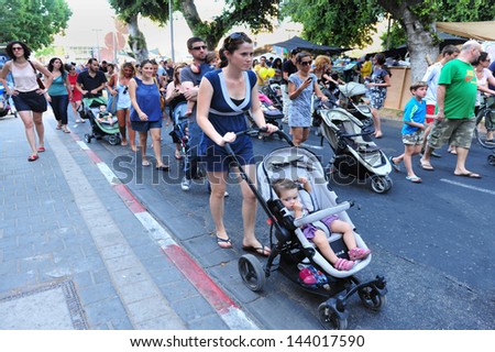 TEL AVIV - JULY 28 :Israeli parents during the 'strollers march'  on July 28 2011.Thousands of parents across Israel stage 'strollers march' in protest of the high costs of raising a child in Israel.