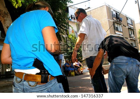 ASHKELON, ISR - AUG 25:Police detectives at work on Aug 25 2006.In criminal investigations when detective has suspects in mind he need to produce evidence that will stand up in a court of law.