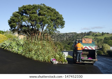 CABLE BAY, NZ - JULY 25:Waste management worker on July 25 2013. The number of landfills in NZ decreased since 1995 from 327 to less than 100 today and most of New Zealand recycle is sent to China.