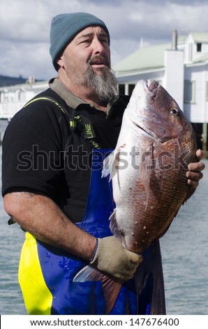 MANGONUI, NZ - JULY 25:Fisherman holds very large Snapper on July 25 2013.NZ exclusive economic zone covers 4.1 million km2,It\'s the 6th largest zone in the world and 14 times the size of NZ.