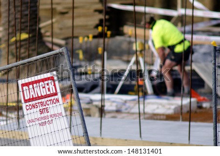 AUCKLAND, NZ -JULY 29: Construction site safety sign and worker without hard hat on July 29 2013.Construction is one of the most dangerous land-based work sector in the world.