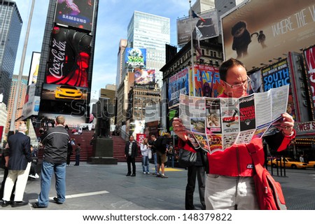 Ny - Oct 08:Man Reads A Brochure Of Broadways Shows In Time Square On October 08 2010.It\'S One Of The World\'S Busiest Pedestrian Intersections And A Major Center Of The World\'S Entertainment Industry.