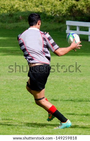 KAITAIA, NZ - AUG 03:Man plays Rugby on Aug 03 2013.Rugby union is the unofficial national sport of NZ. The national team, the All Blacks, rank as the top international team in the world.