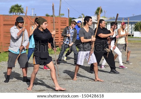 KAITAIA, NZ - AUG 15:Maori chief teach young men Mau Rakau martial art on Aug 15 2013.It\'s  ancient Maori martial art that teaches the use of the Taiaha and other Maori weapons in face to face combat.