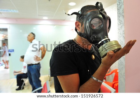 ASHDOD, ISRAEL - APRIL 6: Israeli man testing gas mask on April 06 2010.Reports of a possible American attack in Syria have caused a sharp rise in the number of Israelis seeking gas masks.