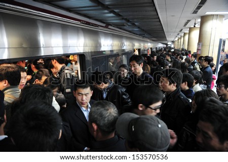 BEIJING - MARCH 15:Crowded scene of Beijing\'s subway during rush hour on March 15 2009 in Beijing,China. It transports about 7 million people every day.
