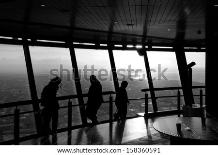 AUCKLAND, NZ - OCT 08: Visitors at the Sky Tower observation deck on Oct 08 2013.At 328 metres, the Sky Tower is the tallest man-made structure in New Zealand.(BW)