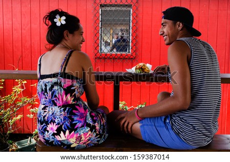 RAROTONGA - SEP 21:Cook Islander couple eat out in a local restaurant on Sep 21 2013.The Cook Islands\' main population centers are on the island of Rarotonga (14,153 in 2006)
