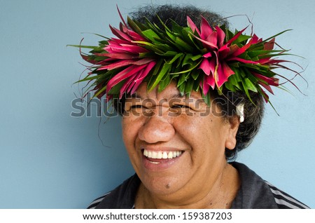 RAROTONGA - SEP 21:Pacific Islander woman with exotic flower top on Sep 21 2013.The Cook Islands\' main population centers are on the island of Rarotonga (14,153 in 2006)