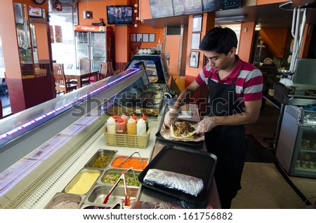 AUCKLAND, NZ - OCT 07:Man prepare doner kabab on Oct 07 2013.It\'s and Ottoman a Turkish dish from the 18th century. The Greek gyro, Arab shawarma, and Mexican taco al pastor are derived from this dish