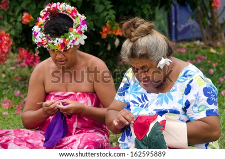 Portrait of Polynesian Pacific Island Tahitian mature females sewing Tivaivai outside their home in Aitutaki lagoon Cook Islands.