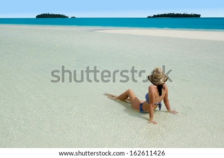 Sexy young woman relaxing on Aitutaki Lagoon, Cook Islands.Concept photo of women freedom, travel, vacation ,happy, happiness, solo, alone, single, fun.
