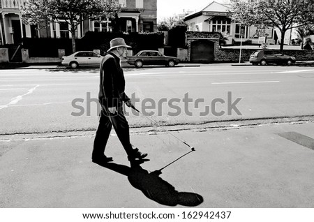 AUCKLAND - OCT 06:Blind man walks with a cane in the street on Oct 06 2013.According to the World Health Organization, 285 million people are estimated to be visually impaired worldwide