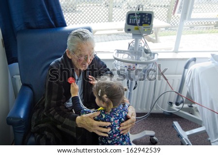 Girl measuring heart beats to here grandfather.