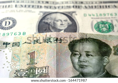 One Chinese Yuan bill (Mao Zedong) on one American Dollar money (George Washington.Concept photo of economy currency strategy growth,corporate assets,national debt and debtor and world power leaders.