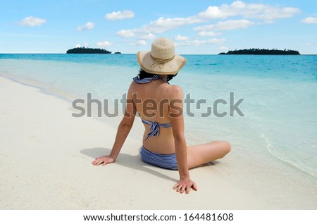 Sexy young woman with hat relaxing on Aitutaki Lagoon, Cook Islands. women freedom, travel, vacation ,happy, happiness, solo, alone, single, fun.