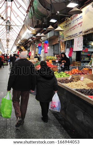 JERUSALEM, ISR - JUNE 02:Shoppers at Mahane Yehuda Market on June 06 2011.It\'s an outdoor marketplace in Jerusalem, Israel. Popular with locals and tourists alike.