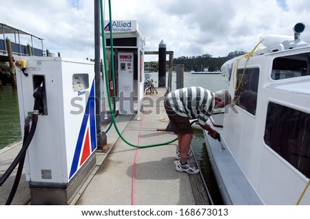 BAY OF ISLANDS, NZ - DEC 12:Man fuels his boat on Dec 12 2013.According to the world bank the pump price for diesel fuel in NZ in 2013 is 1.24 (US $ per liter)