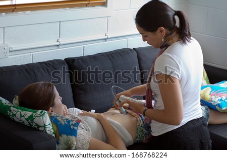 CABLE BAY,NZ:Midwife checks baby heart beat and movement on Dec 12 2013.Midwifery is a health care profession in which providers offer care to women during pregnancy,labor ,birth and postpartum.