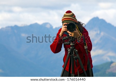 Professional nature and landscape photographer (woman) at work outdoor on location.